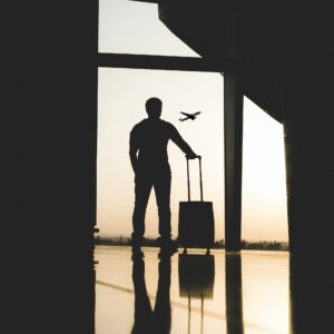 Traveller with luggage inside an airport terminal